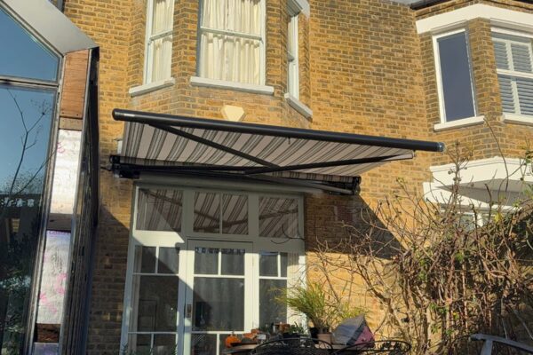 Markilux awning partially extended over rear patio doors in Herne Hill.