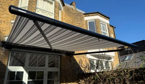 lose-up of striped Markilux awning fabric and arms from below