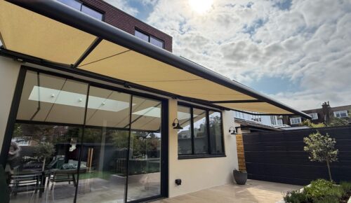 Side view of large Markilux patio awning extended across rear extension in Wandsworth Common