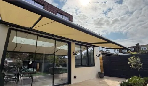 Side view of large Markilux patio awning extended across rear extension in Wandsworth Common