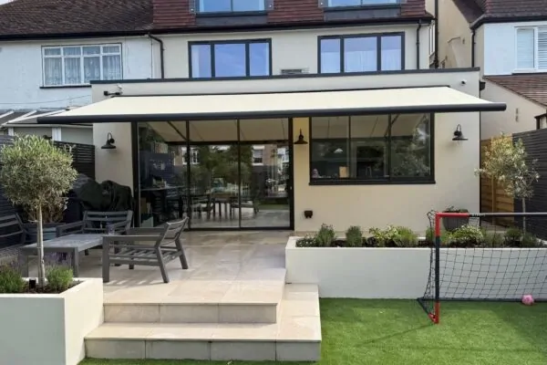 Full rear view of patio awning shading terrace and sliding doors in Wandsworth Common.