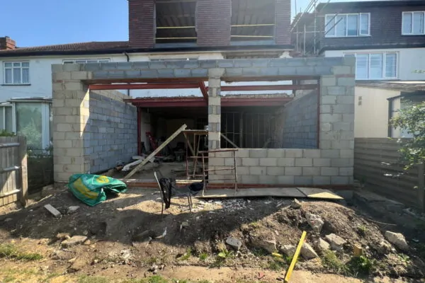 Rear extension under construction with structure prepared for bespoke awning brackets.